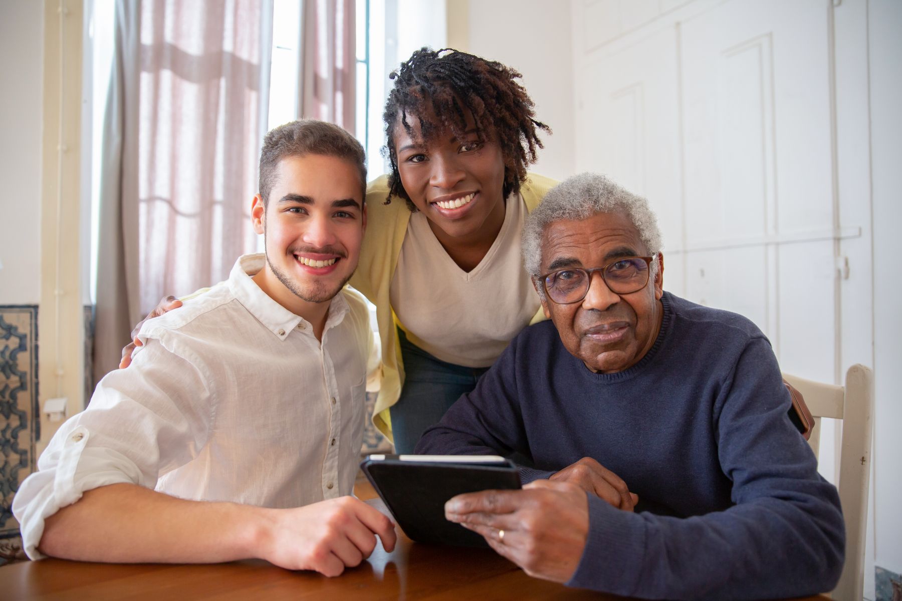 Senior citizen reviewing care information at home with family support